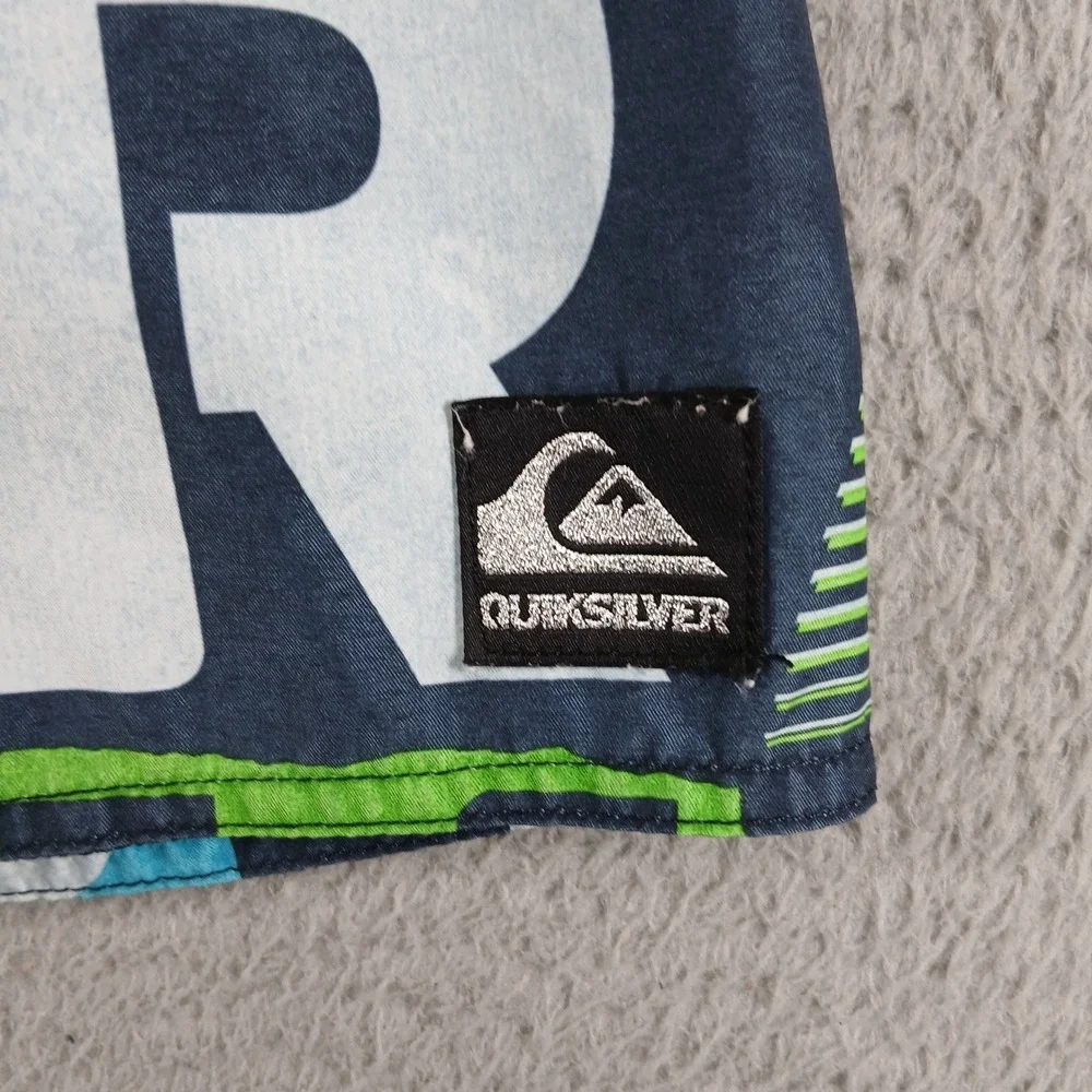 Quiksilver Board Shorts All Over Logo Spellout Swim Trunks Size 28 Blue Lime EUC